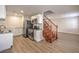 Open-concept kitchen with stainless appliances, granite counters, and adjacent staircase at 5330 E Charleston Blvd # 28, Las Vegas, NV 89142