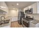 Well-lit kitchen with stainless steel appliances, granite countertops, and white cabinets at 5330 E Charleston Blvd # 28, Las Vegas, NV 89142