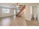 Spacious living room with wood-look flooring, bright windows, and staircase access at 5330 E Charleston Blvd # 28, Las Vegas, NV 89142