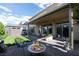 Inviting backyard with a covered patio, seating area, and well-maintained lawn at 5850 Rockway Glen Ave, Las Vegas, NV 89141