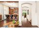 Stylish home bar featuring custom wood accents, modern lighting, and beautiful archway at 5850 Rockway Glen Ave, Las Vegas, NV 89141