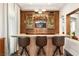Stylish home bar featuring custom wood accents, modern lighting, and beautiful display shelves at 5850 Rockway Glen Ave, Las Vegas, NV 89141