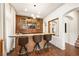 Stylish home bar featuring custom wood accents, modern lighting, and comfortable seating at 5850 Rockway Glen Ave, Las Vegas, NV 89141