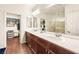 Elegant bathroom with dual sinks, marble countertops, and a glass-enclosed shower, offering a spa-like experience at 5850 Rockway Glen Ave, Las Vegas, NV 89141
