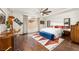 Stylish bedroom boasts ample natural light, modern ceiling fan and sleek, wooden furnishings at 5850 Rockway Glen Ave, Las Vegas, NV 89141