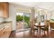 Dining room with wood table and chairs next to sliding glass doors leading to the backyard at 5850 Rockway Glen Ave, Las Vegas, NV 89141