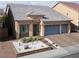 Well-maintained home with a three-car garage, desert landscaping, and a welcoming entrance at 5850 Rockway Glen Ave, Las Vegas, NV 89141