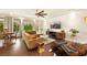Bright open living space featuring hardwood floors, recessed lighting, and a modern ceiling fan with views outside at 5850 Rockway Glen Ave, Las Vegas, NV 89141