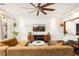 Cozy living room with hardwood floors, recessed lighting, modern ceiling fan, a stylish TV console, and comfortable seating at 5850 Rockway Glen Ave, Las Vegas, NV 89141