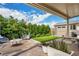Charming backyard patio with lush landscaping, seating, and a storage shed at 5850 Rockway Glen Ave, Las Vegas, NV 89141