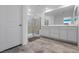 Bright bathroom featuring a glass shower, gray tile floors, and a large vanity at 5937 W Frias Ave, Las Vegas, NV 89141