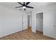 This bedroom features a ceiling fan, wood-look flooring, and a double door closet at 5937 W Frias Ave, Las Vegas, NV 89141