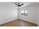 Bright bedroom features a ceiling fan, wood-look flooring, and a view from the window at 5937 W Frias Ave, Las Vegas, NV 89141