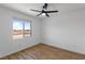 This bedroom features a ceiling fan, wood-look flooring, and bright light at 5937 W Frias Ave, Las Vegas, NV 89141