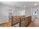 Bright hallway featuring wood flooring and a staircase with wood railing at 5937 W Frias Ave, Las Vegas, NV 89141