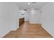 Bright hallway with wood floors, white walls, and a view of the stairs at 5937 W Frias Ave, Las Vegas, NV 89141