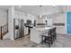 Bright kitchen features stainless steel appliances, an island with seating, and sleek white cabinetry at 5937 W Frias Ave, Las Vegas, NV 89141
