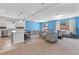 Open-concept living area featuring a breakfast bar, dining area, and comfortable seating at 5937 W Frias Ave, Las Vegas, NV 89141