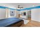 Spacious main bedroom featuring a window, wood floors, and a modern ceiling fan at 5937 W Frias Ave, Las Vegas, NV 89141