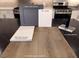 Kitchen finishes showcasing luxury vinyl plank flooring, grey cabinets, and white counter tops for a modern aesthetic at 5941 Violet Crown St, North Las Vegas, NV 89081