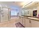 Bathroom featuring double sinks, granite countertops, and a separate bathtub and shower at 6046 Castle Gardens Ave, Las Vegas, NV 89130