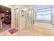 Bright bathroom featuring a shower over tub and a door to a walk-in closet at 6046 Castle Gardens Ave, Las Vegas, NV 89130