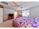 Bright bedroom featuring a ceiling fan, carpeted floor, and a purple floral-patterned bedspread at 6046 Castle Gardens Ave, Las Vegas, NV 89130