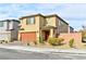 Two-story home showcasing a landscaped front yard and a two-car garage at 6046 Castle Gardens Ave, Las Vegas, NV 89130
