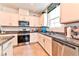 Bright kitchen with stainless steel appliances, granite counters and modern fixtures at 6046 Castle Gardens Ave, Las Vegas, NV 89130
