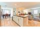 Open concept kitchen with granite island and dining area at 6046 Castle Gardens Ave, Las Vegas, NV 89130