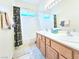 Bright bathroom featuring a double vanity, shower/tub combo, and neutral tile flooring at 6269 Bold Regatta Ct, Las Vegas, NV 89139