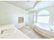 Bright bathroom with tub, step-in shower, and single vanity with white counters and tile floors at 6269 Bold Regatta Ct, Las Vegas, NV 89139