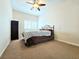 Neutral bedroom with standard closet, ceiling fan, and shuttered window, and carpeted flooring at 6269 Bold Regatta Ct, Las Vegas, NV 89139