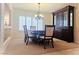 Dining room featuring a chandelier, classic wood furniture, and a large window at 6269 Bold Regatta Ct, Las Vegas, NV 89139