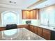 Well-lit kitchen featuring wooden cabinets, granite countertops, and stainless steel appliances at 6269 Bold Regatta Ct, Las Vegas, NV 89139