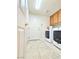 Laundry room with a washing machine, dryer, tile floor, and overhead cabinets at 6269 Bold Regatta Ct, Las Vegas, NV 89139