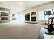 Open-concept living room with fireplace, large windows, and sliding glass doors to outside at 6269 Bold Regatta Ct, Las Vegas, NV 89139