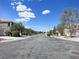 A wide view of a neighborhood street on a sunny day, showcasing the community's well-maintained appearance at 6269 Bold Regatta Ct, Las Vegas, NV 89139