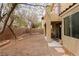 Enclosed backyard with low maintenance gravel, brick accents, and patio area at 6279 Dollar Bill Ct, Las Vegas, NV 89141