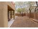 View of the backyard featuring a small patio and low-maintenance desert landscaping at 6279 Dollar Bill Ct, Las Vegas, NV 89141