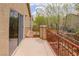 A cozy outdoor balcony with a red iron railing offering space for relaxation with a glimpse of the neighborhood scenery at 6279 Dollar Bill Ct, Las Vegas, NV 89141