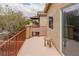 Outdoor balcony featuring red iron railing, tile flooring, and neutral stucco exterior, offering views of the backyard at 6279 Dollar Bill Ct, Las Vegas, NV 89141