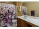 Bathroom features a vanity with sink, toilet, and shower with floral curtain at 6279 Dollar Bill Ct, Las Vegas, NV 89141