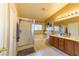 Well-lit bathroom with dual sink vanity, bathtub, and shower, featuring tile floors and neutral paint at 6279 Dollar Bill Ct, Las Vegas, NV 89141