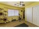 Cozy bedroom with exercise equipment, carpet, window, and closet; offering space for relaxation and exercise at 6279 Dollar Bill Ct, Las Vegas, NV 89141
