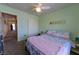 Well-lit bedroom with ceiling fan, plush carpet, and easy access to hallway at 6279 Dollar Bill Ct, Las Vegas, NV 89141