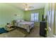 Cozy bedroom features light green walls, ceiling fan, and plush carpet at 6279 Dollar Bill Ct, Las Vegas, NV 89141