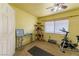 Bright, carpeted room offers plenty of space for exercise equipment and a cat tree at 6279 Dollar Bill Ct, Las Vegas, NV 89141