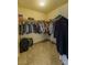 Walk-in closet with organized storage, hanging rods, and carpet flooring; creating an efficient space for clothing and accessories at 6279 Dollar Bill Ct, Las Vegas, NV 89141