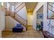 Welcoming entryway with wood staircase, tiled floor, and neutral colors at 6279 Dollar Bill Ct, Las Vegas, NV 89141